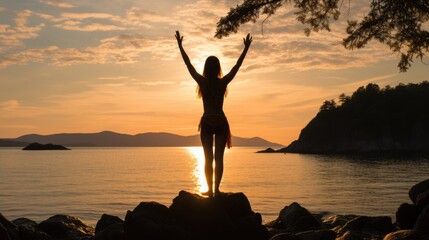 Athletic woman meditates and dances on the beach. Silhouette against the backdrop of a sunset or dawn, a beautiful landscape and unity with nature. Yoga, Pilates, Chakra and Zen meditation
