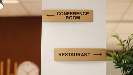Close up of directions signs to restaurant, conference room and spa center amenities. Hotel...