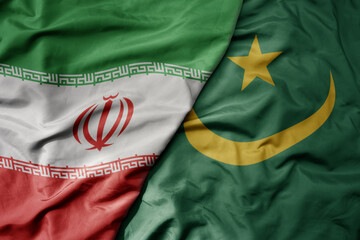 big waving realistic national colorful flag of iran and national flag of mauritania .