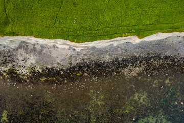 Cliff near Silverstrand beach and car park in Galway city, Ireland. Popular tourist place with stunning view on Galway bay and Burren mountains. Blue hour. Aerial view. Calm nature scene.