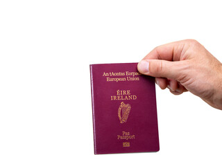 Passport of Ireland with in a hand on white background. ID document of Ireland with traditional harp symbol and written in Irish and English language.