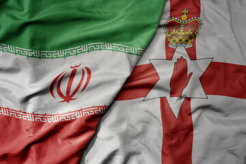 big waving realistic national colorful flag of iran and national flag of northern ireland .