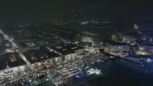 Helsinki.Finland-December 31.2021: Aerial shot showing the centre of Helsinki during fireworks. Beautiful cityscape. Nighttime. New years eve. Wintertime. Camera slowly moving sideways.