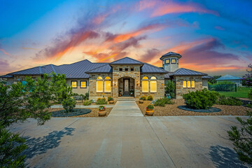 a house at sunset with colorful clouds - obrazy, fototapety, plakaty