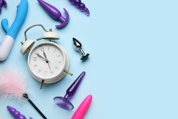 Alarm clock with sex toys on blue background - obrazy, fototapety, plakaty