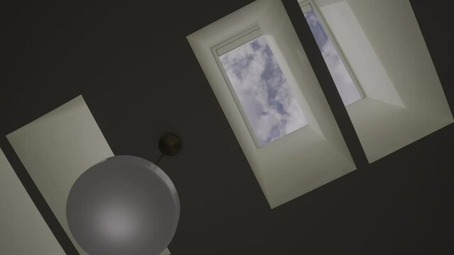This time lapse video shows clouds pass by through ceiling skylights.