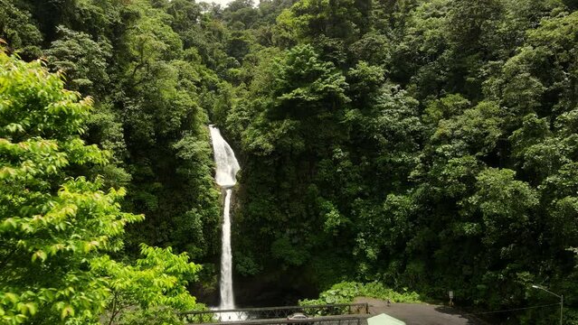 Aerial shot of a waterfall in Costa Rica. The waterfall is surrounded by jungle but the road is nearby. Tourist spot near La Fortuna. La Paz waterfall