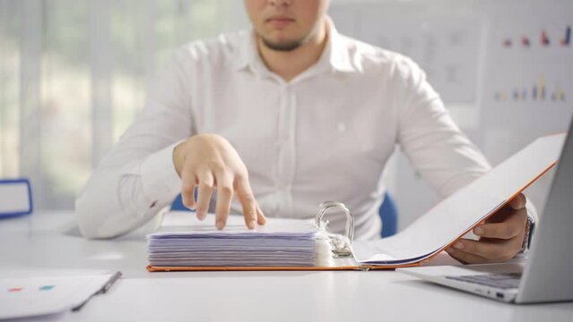 Businessman working looking at files.