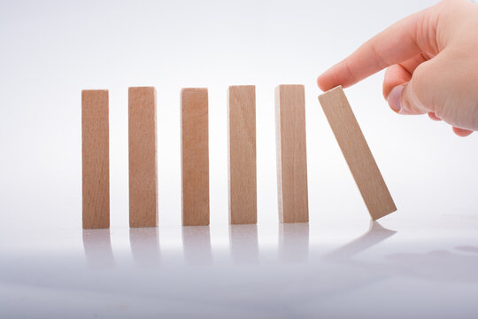 Hand holding wooden domino