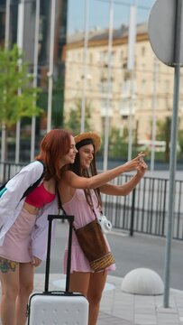 On the city streets, two lively young ladies are capturing each other's photos.