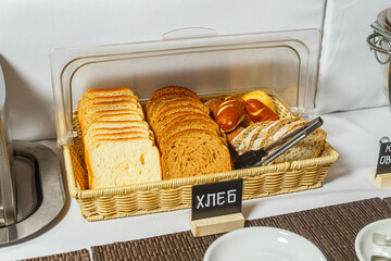 Slices of bread in a wicker basket on the table