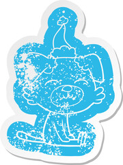quirky cartoon distressed sticker of a dog wearing santa hat