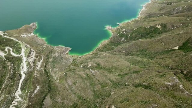 aerial of laguna quilotoa at the quilotoa loop in the andes mountains of Ecuador, is an emerald green lake in a caldera of an old volcano cater and a popular travel destination for hikers.