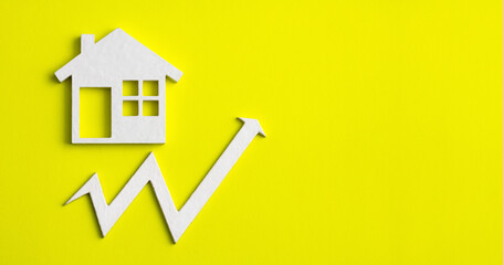 Fototapeta na wymiar Increase in real estate value - House icon with arrow on yellow background