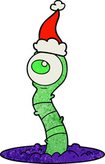 hand drawn textured cartoon of a alien swamp monster wearing santa hat