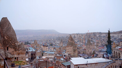 Aerial view of a summer southern city on a cloudy sky background. Action. Many roofs of buildings.