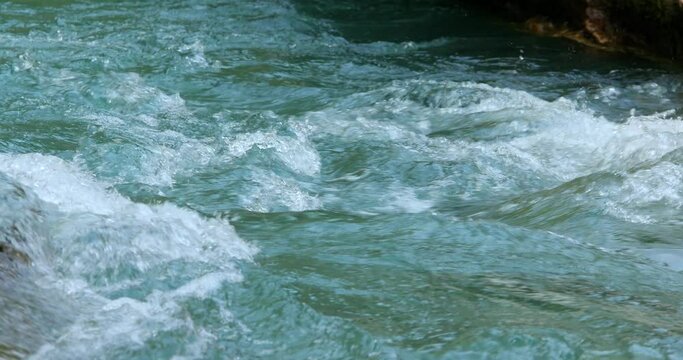 rapid flow of a mountain river with emerald water close-up. High quality 4k footage