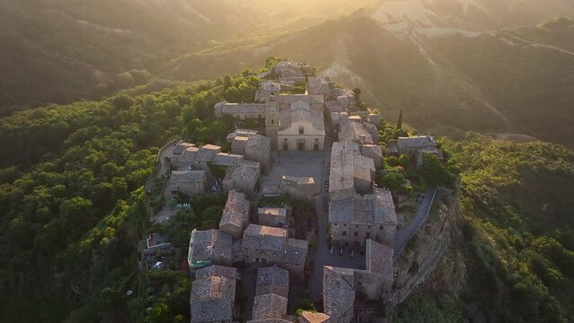 Civita di Bagnoregio, aerial view at sunrise, located on top of a volcanic tuff hill overlooking the Tiber river valley, province of Viterbo, Lazio, Italy