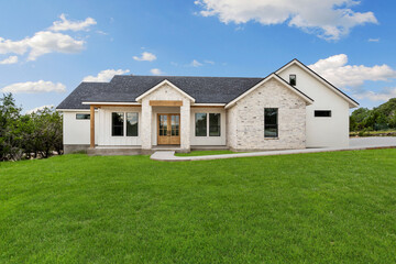 the front view of a home with a yard  - Powered by Adobe