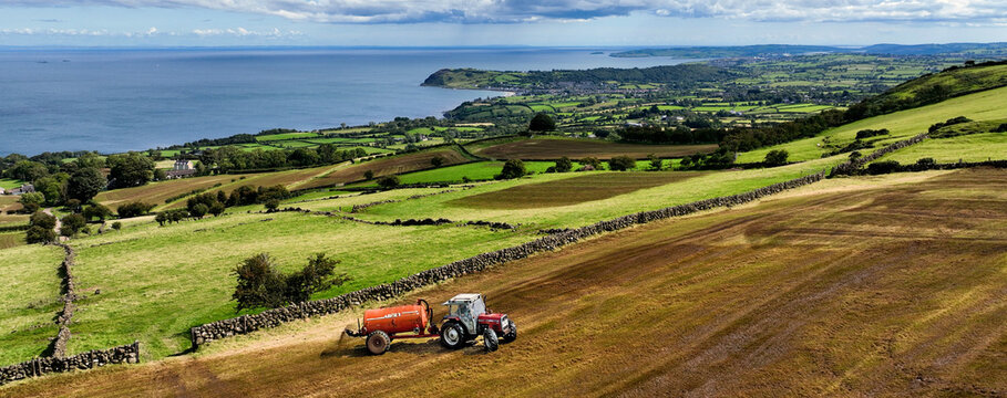 Aerial Photo of Massey Ferguson 390T Tractor and Abbey Tanker spreading manure slurry in a field on farm in UK 09-09-23