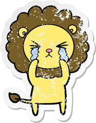 distressed sticker of a cartoon crying lion