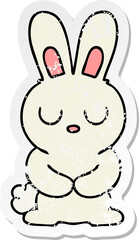 distressed sticker of a quirky hand drawn cartoon rabbit