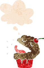 cartoon cupcake with thought bubble in grunge distressed retro textured style