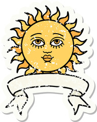 worn old sticker with banner of a sun with face