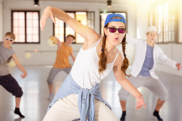 Group of teenagers dancing hip-hop and enjoying it