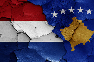 flags of Netherlands and Kosovo painted on cracked wall