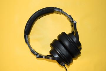 top view headphone with cable on yellow background