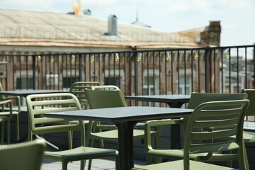 Observation area cafe. Tables and chairs on terrace against beautiful cityscape