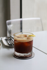 Ice coffee Espresso Tonic soda water with lime juice with sliced lemon on white table. Cold brew. Summer drinks. Homemade Refreshing Beverage.