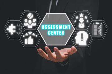 Assessment center concept, Businessman hand holding assessment center icon on virtual screen.