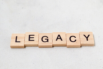Top view of Legacy word on wooden cube letter block on white background. Business concept