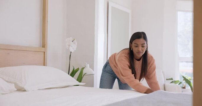 Woman, making up bed and chore in bedroom, morning routine and neat or organized in domestic.Indian person, straightening and cleaning the bed sheet, blanket and bedding at home, tidy and housework