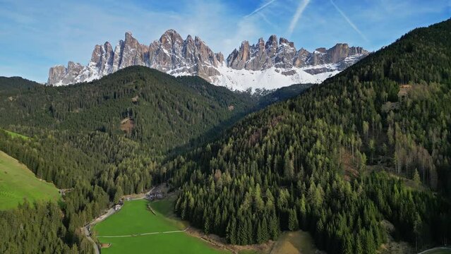 Spring landscape with shurch in Santa Magdalena village, Italian Dolomites Alps, in South Tyrol, Val di Funes, Italy, 4k