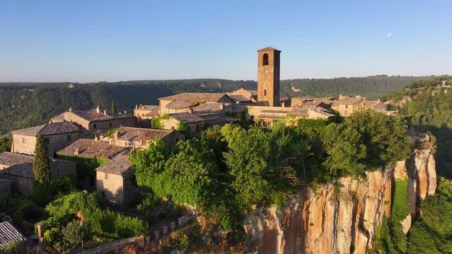 Civita di Bagnoregio, aerial view at sunrise, located on top of a volcanic tuff hill overlooking the Tiber river valley, province of Viterbo, Lazio, Italy