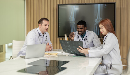 Surgeon and radiologist discuss Patient's knee joint 's MRI, plan for further procedure.