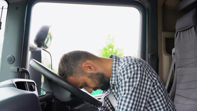Truck driver sleeping in his cabin after working long routes overtime. Lack of sleep