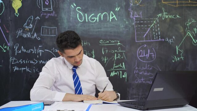 Businessman writes Sigma on the board and looks at the camera.