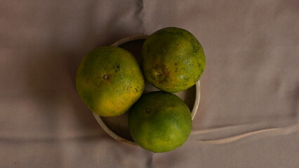 The three oranges above look wooden