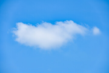 beautiful blue sky and white fluffy single cloud with sunrise in the morning, natural background