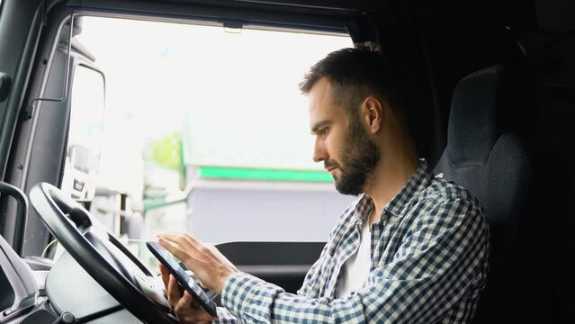 Professional trucker using truck gps navigation to transport and deliver goods to the destination. Right hand drive car