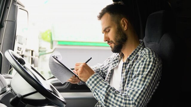 Deliveryman sitting in truck and checking the delivery list