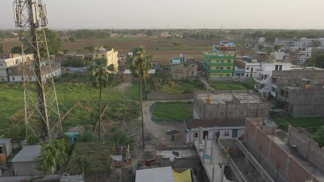 Rural India landscape, concrete buildings and farmland, High angle view