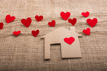 Love concept with paper shaped heart and house