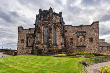 Fototapeta na wymiar Wall and medieval buildings with stone church in Edinburgh Castle, Scotland, UK.