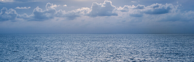 Blue-gray cloudy sky over the Caribbean Sea horizon