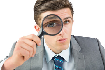 Digital png photo of caucasian businessman looking through magnifier on transparent background